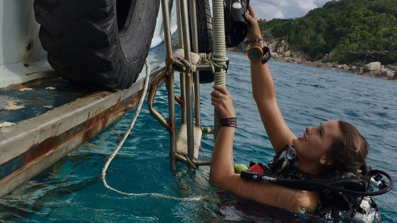 latitudes year student climbing aboard after a dive trip